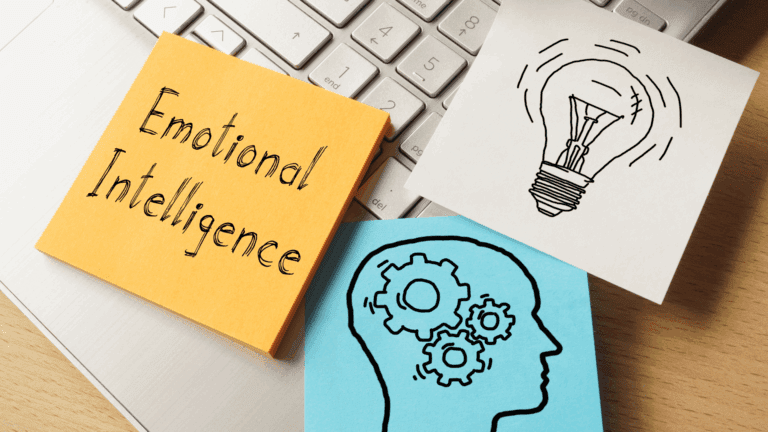 Emotional intelligence concepts illustrated on post-its with a keyboard backdrop.