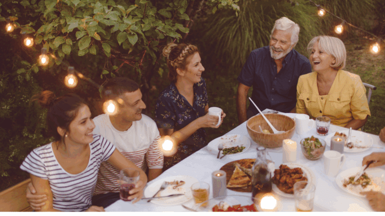a group of people sitting at a table with food