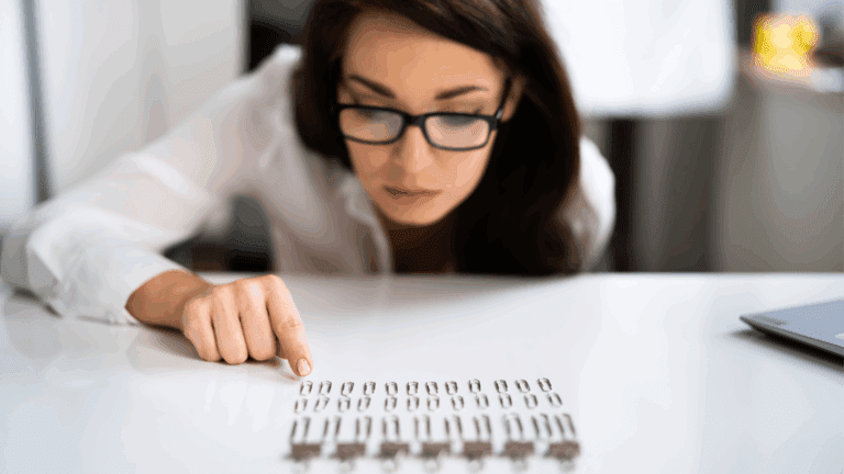 a woman pointing at a row of paper clips