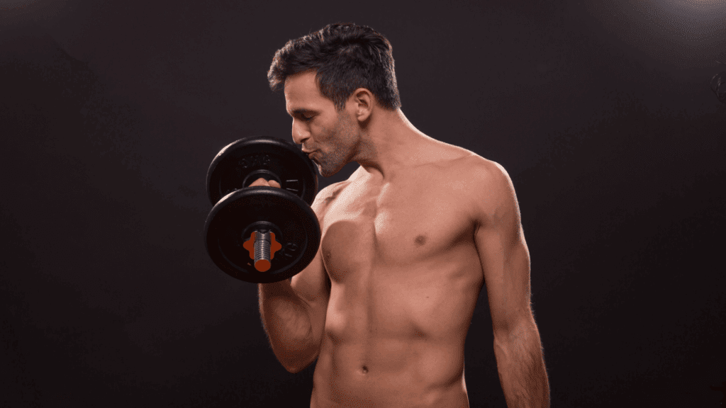 A man lifting weights who is kissing the dumb bell proving he is a narcissist.