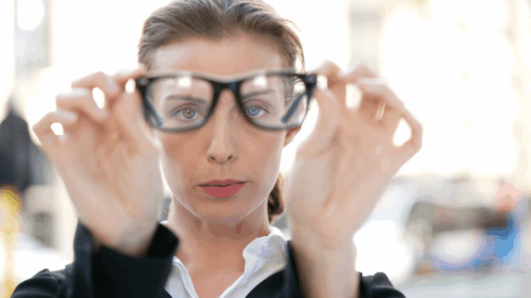 Woman adjusting her glasses, focusing on changing perspective.