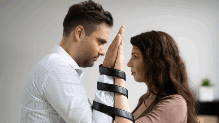 Couple with hands bound together, symbolizing codependency.
