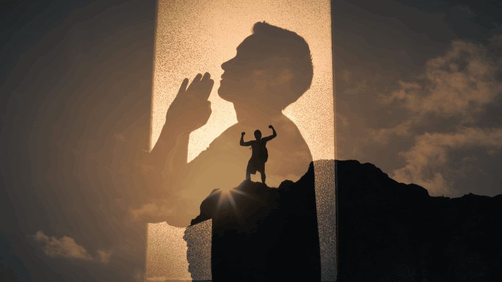Silhouette of person celebrating achievement on mountaintop at sunset