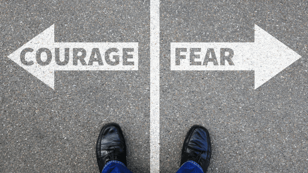 Crossroads showing opposing directions for courage and fear choices