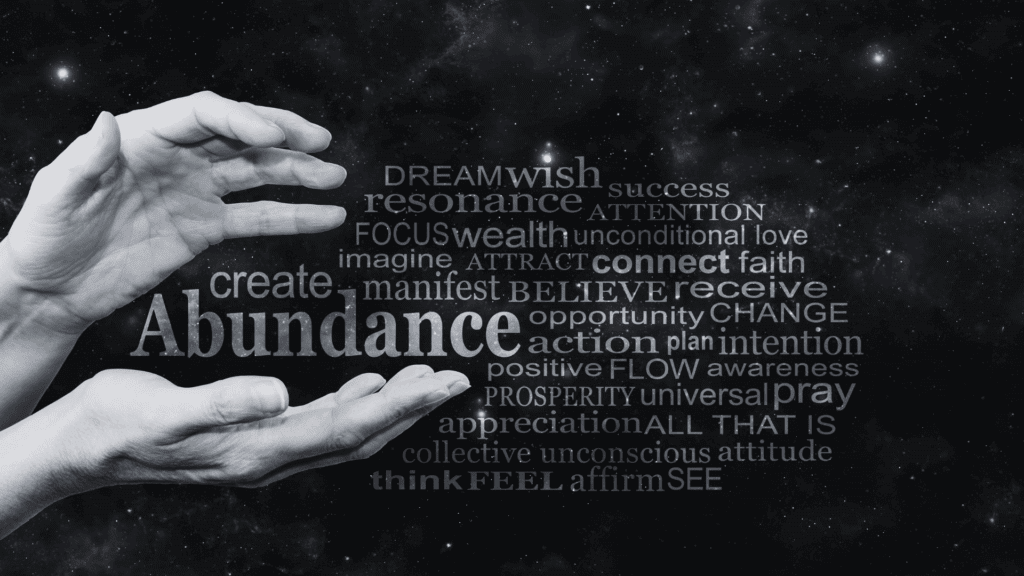 Open hands surrounded by a word cloud with terms like abundance, wealth, and gratitude, representing the concept of holistic wealth.
