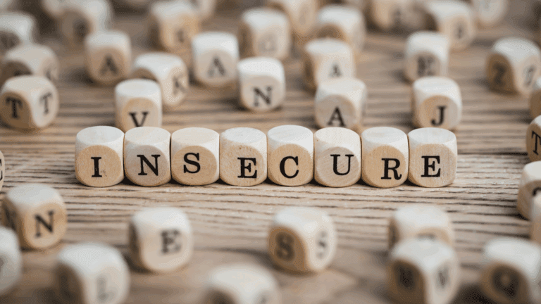 Wooden blocks spelling insecure, representing the neuroscience of insecurity