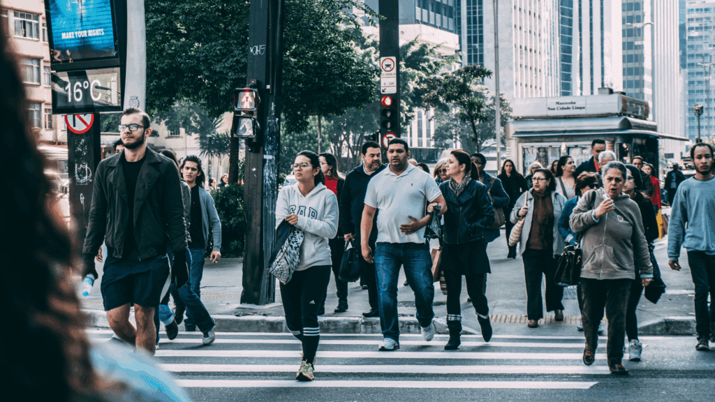 A diverse group of people crossing a city street, reflecting social influences on the neuroscience of anxiety.