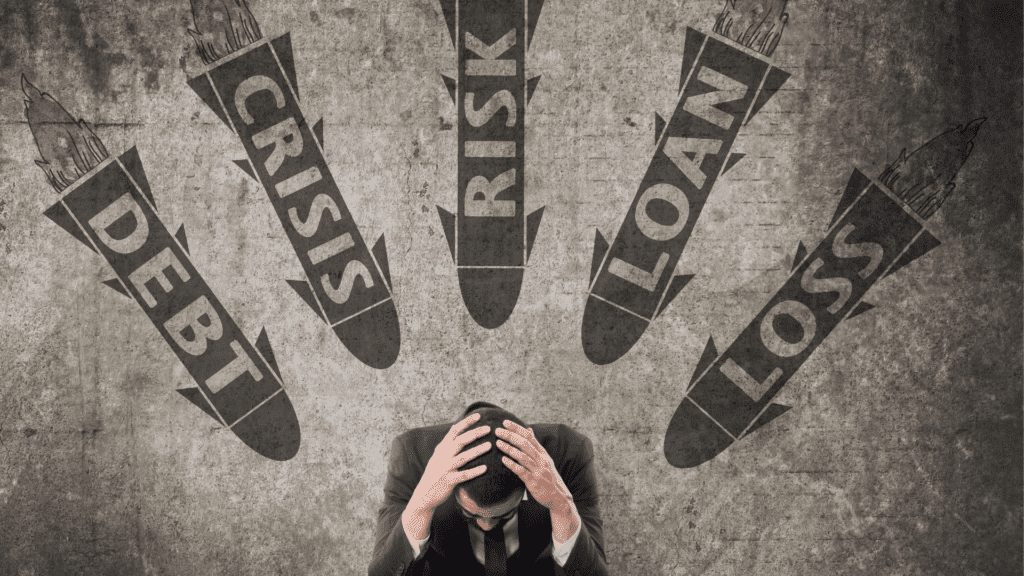 A stressed businessperson holding their head as crisis and debt missiles symbolize the neuroscience of anxiety.