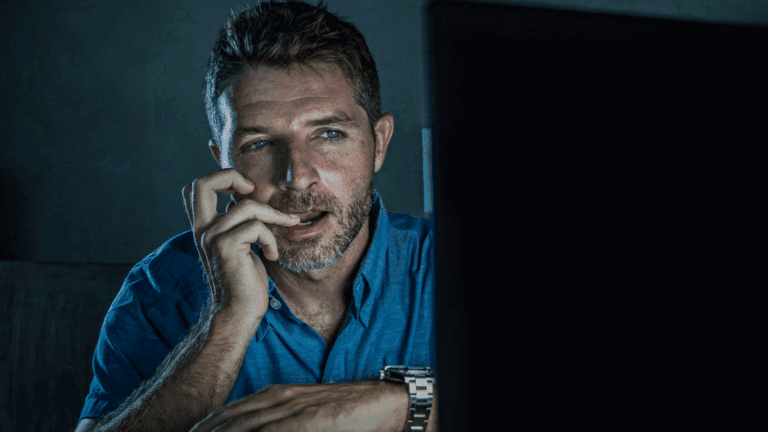 Man looking distressed while using a smartphone, symbolizing the neuroscience of sex addiction and digital triggers