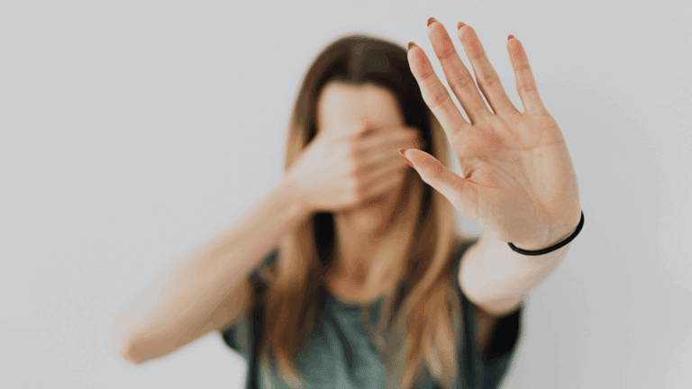 Person holding up a hand in a stop gesture, reflecting resistance to change and readiness for change.