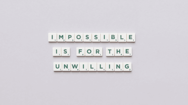 Scrabble tiles spelling “Impossible is for the unwilling” representing mindset mastery