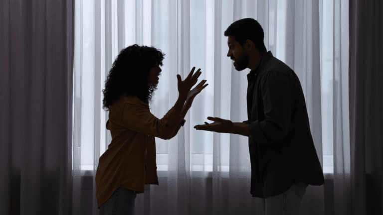 Couple arguing intensely indoors, representing emotional conflict and the neuroscience of contentiousness.