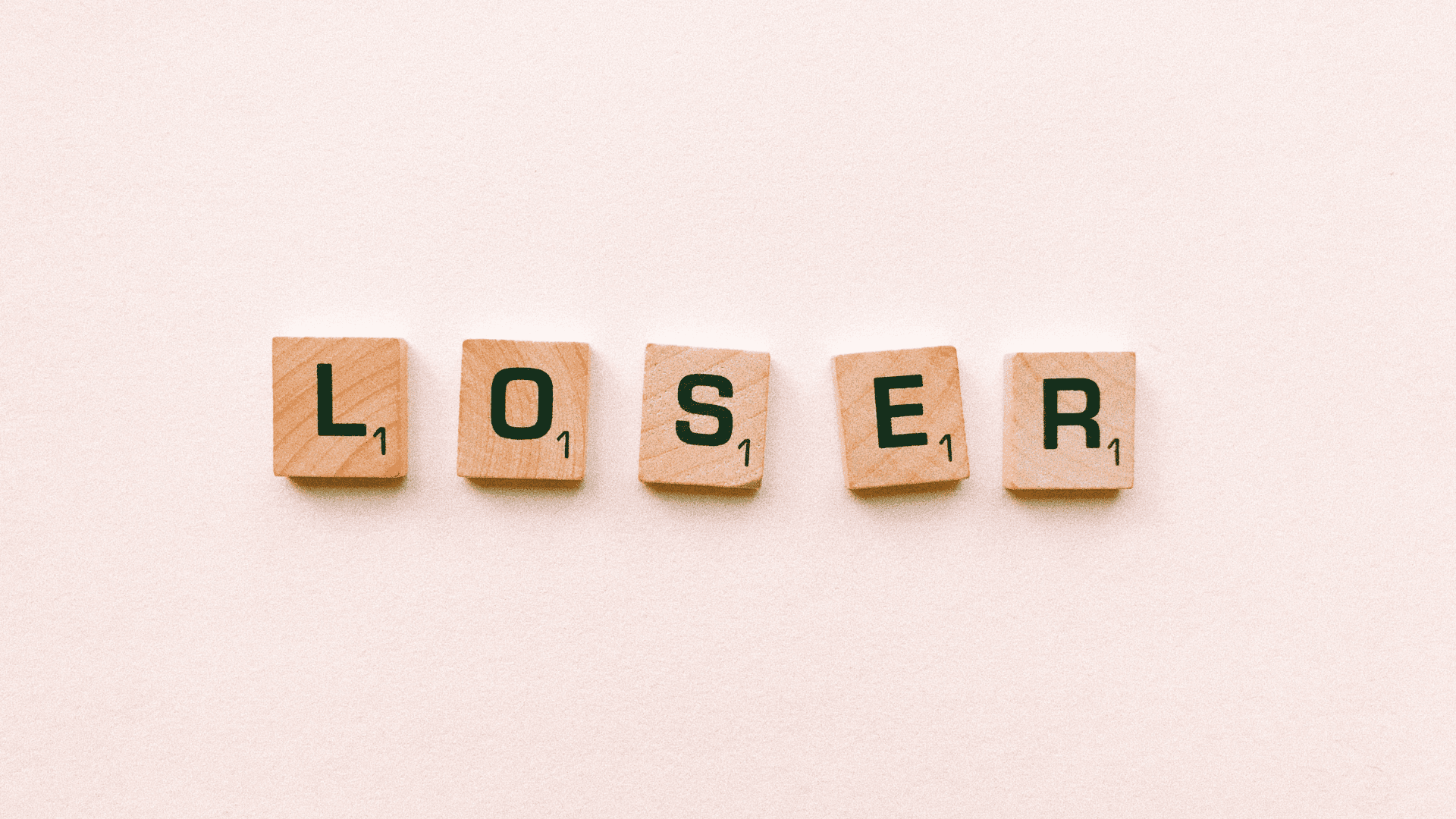 Scrabble tiles spelling loser, representing the inner dialogue of asking, am I a loser.