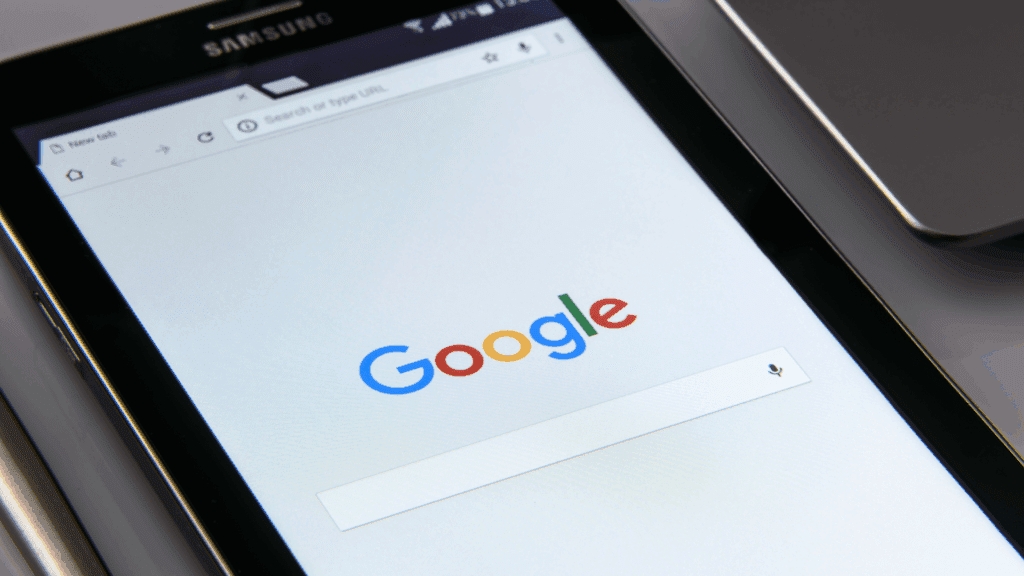A tablet displaying the Google homepage, representing search visibility for topical authority in neuroscience-based coaching.

