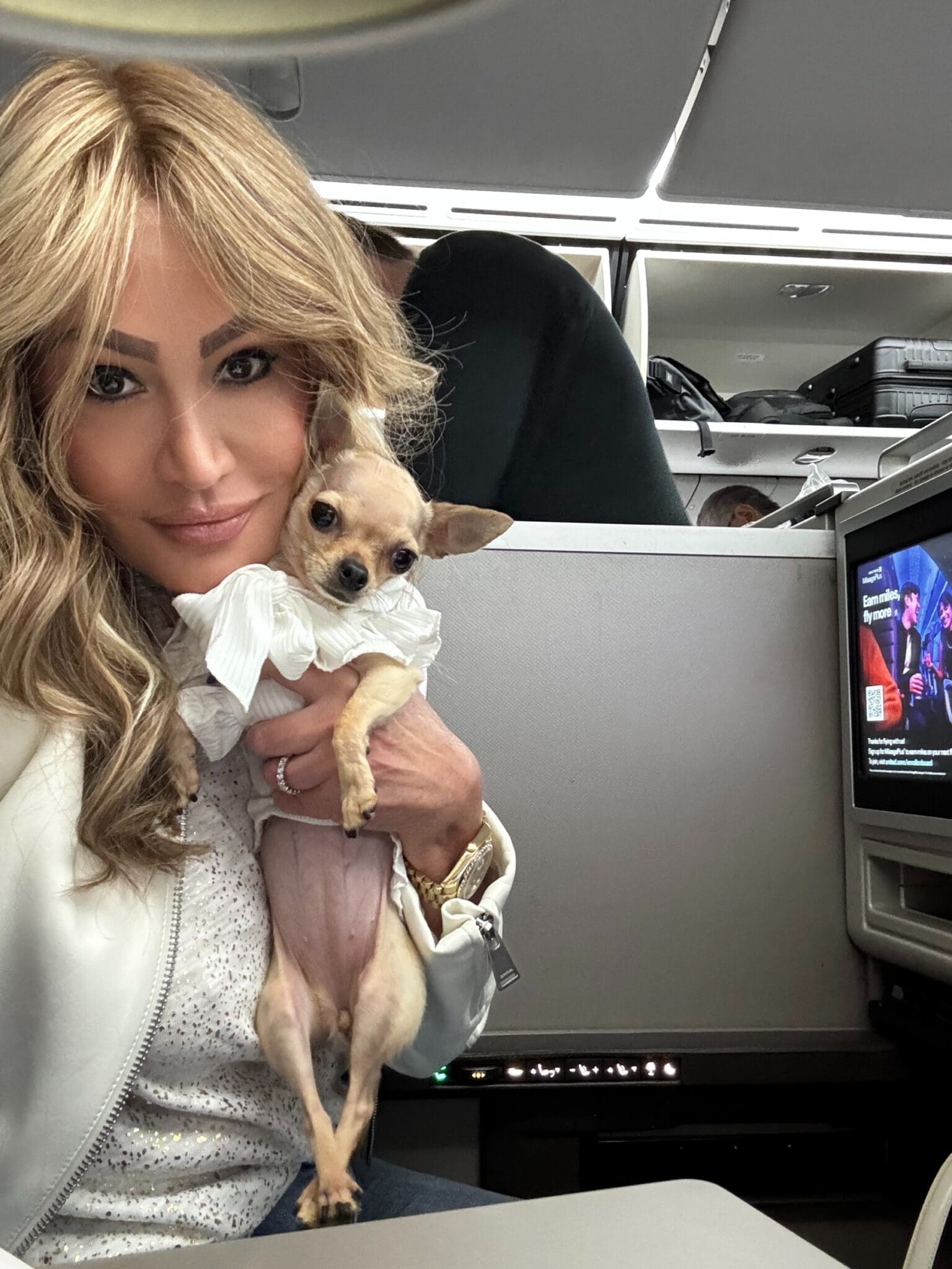 Dr. Sydney Ceruto traveling first class with dog Lola showing high achiever lifestyle
