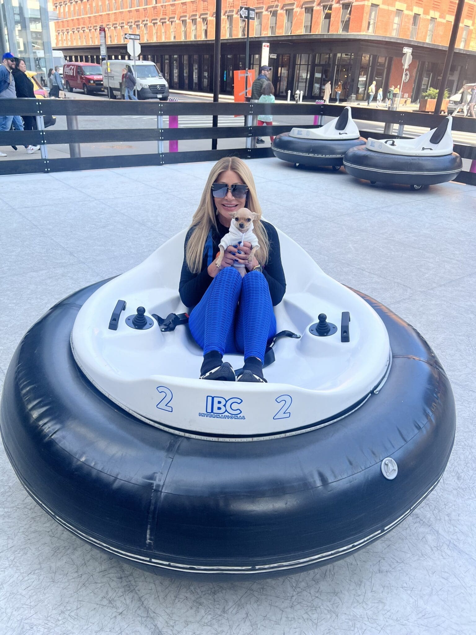 Dr. Sydney Ceruto snow tubing in Meatpacking District NYC with chihuahua Lola showing playful side