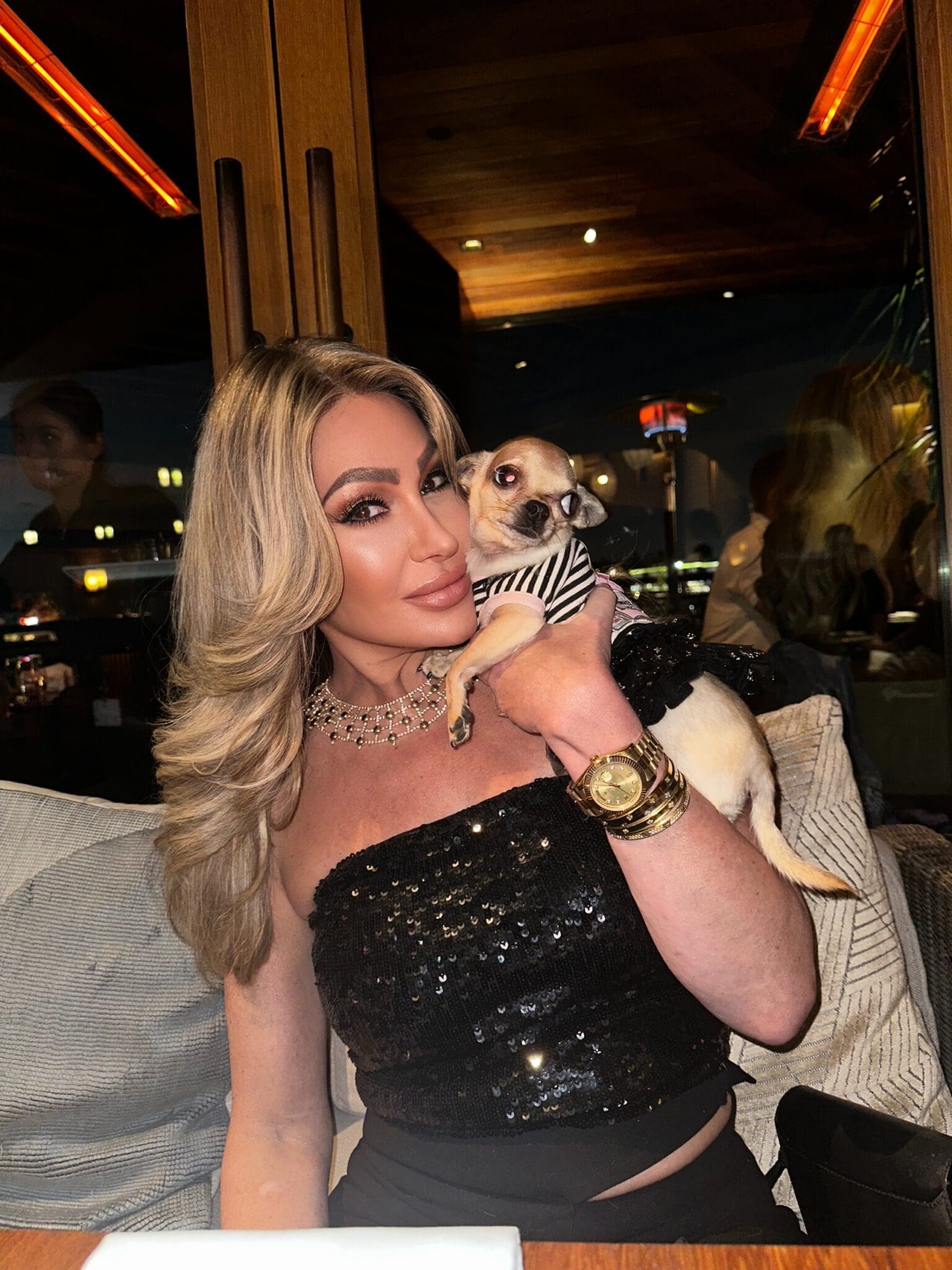 Dr. Sydney Ceruto with her dog Lola at dinner, showing authentic personal connection and loved ones in her life outside of coaching